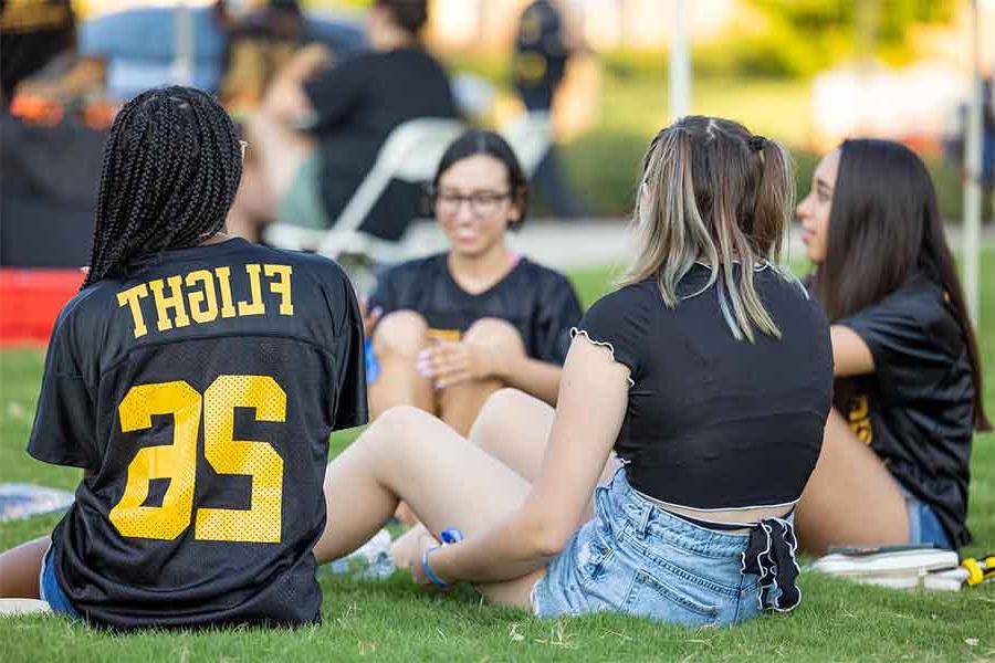 flight students sitting in the grass