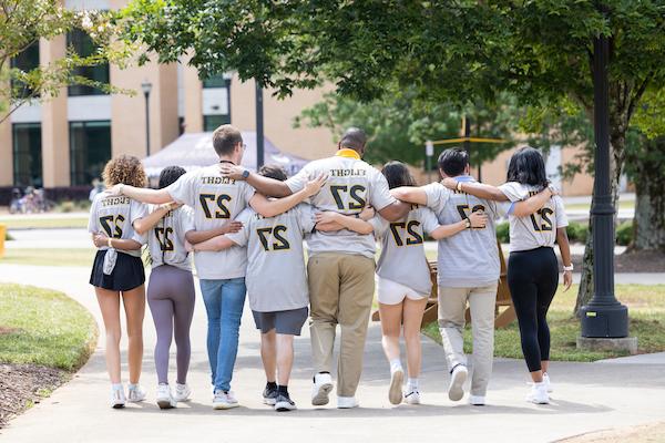 FLIGHT27 Students walking arm in arm