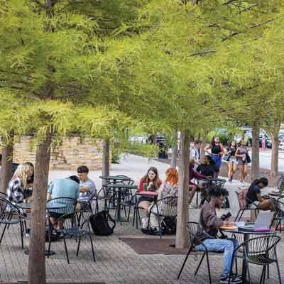 students sitting at tables outside ksu campus