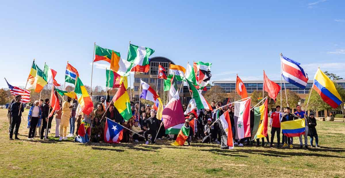 students holding flags on the campus green